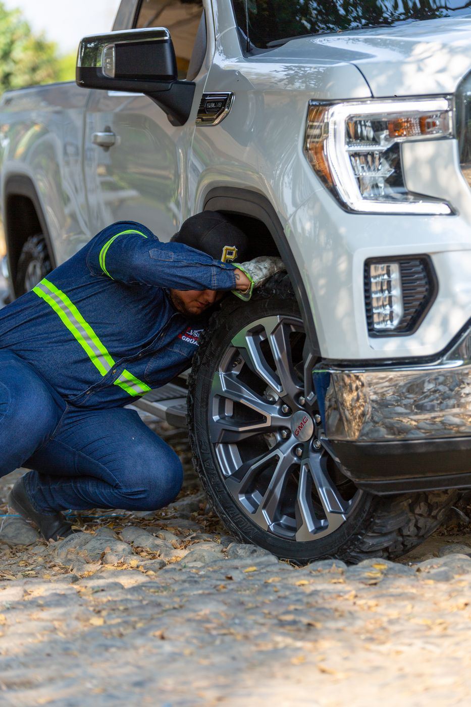 Mechanic performing brake pad installation on a vehicle